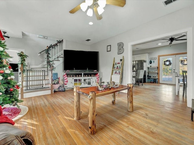 living room with ceiling fan, hardwood / wood-style floors, and french doors