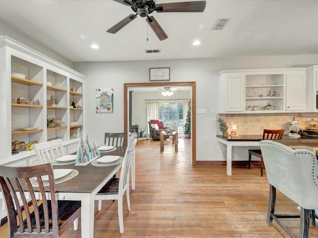 dining space featuring ceiling fan and light wood-type flooring