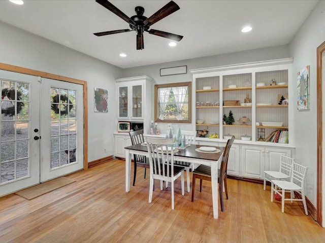 dining room with ceiling fan, light wood-type flooring, and french doors