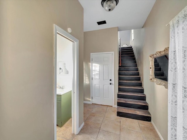 stairway featuring tile patterned flooring