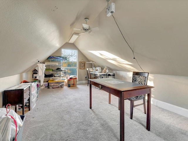 carpeted office featuring ceiling fan, a textured ceiling, and vaulted ceiling