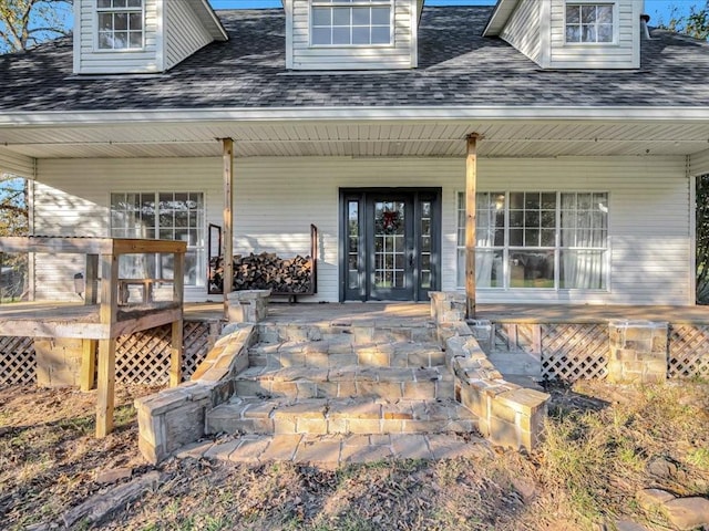 back of property featuring covered porch