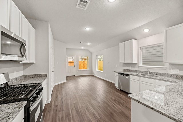 kitchen with white cabinetry, sink, light stone countertops, and appliances with stainless steel finishes