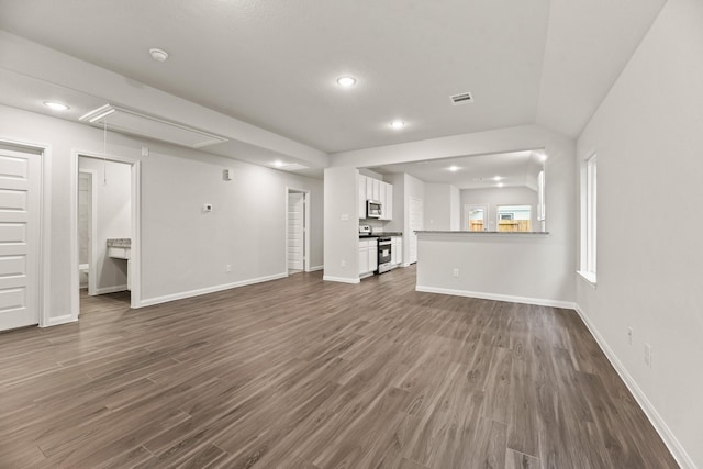 unfurnished living room with dark hardwood / wood-style flooring