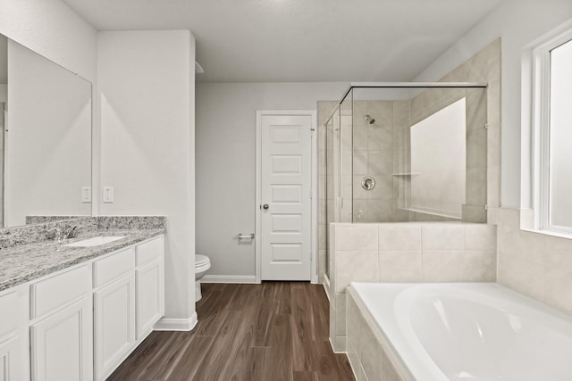 full bathroom with toilet, vanity, hardwood / wood-style flooring, and separate shower and tub