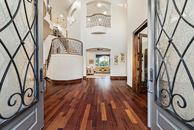 entryway with dark hardwood / wood-style flooring and a high ceiling