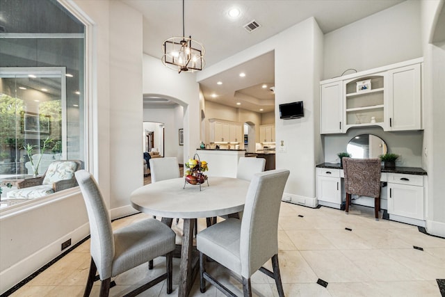 tiled dining space with an inviting chandelier