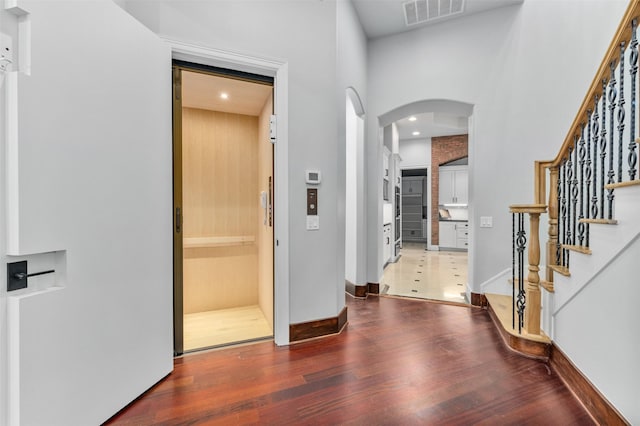 entrance foyer with hardwood / wood-style flooring and elevator