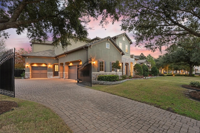 view of front of house featuring a garage and a yard