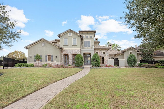 view of front of home featuring a balcony and a front yard