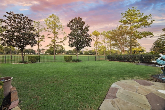 yard at dusk with a patio area