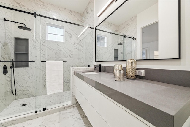 bathroom featuring vanity and a shower with door