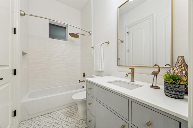 full bathroom with toilet, tile patterned flooring, vanity, and tiled shower / bath