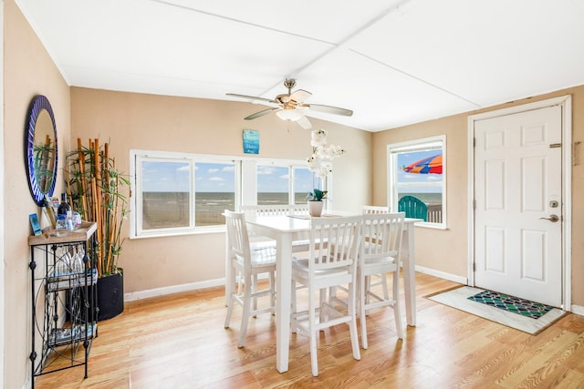 dining space with light wood-style floors, ceiling fan, and baseboards