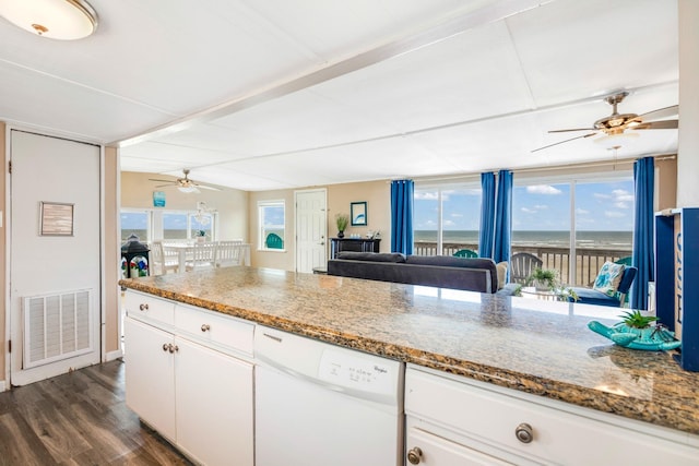 kitchen with light stone countertops, a water view, white cabinets, and white dishwasher