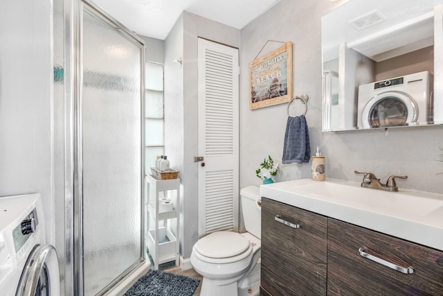 full bath with a closet, visible vents, a stall shower, vanity, and washer / dryer