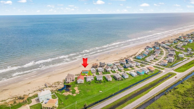 birds eye view of property featuring a beach view and a water view