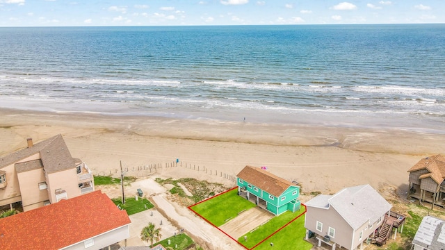 bird's eye view featuring a view of the beach and a water view