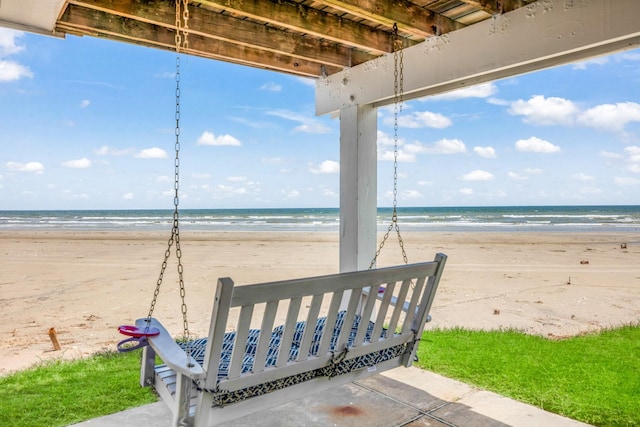 exterior space with a water view and a beach view