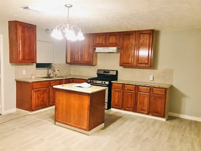 kitchen with stainless steel gas range, sink, pendant lighting, an inviting chandelier, and a center island