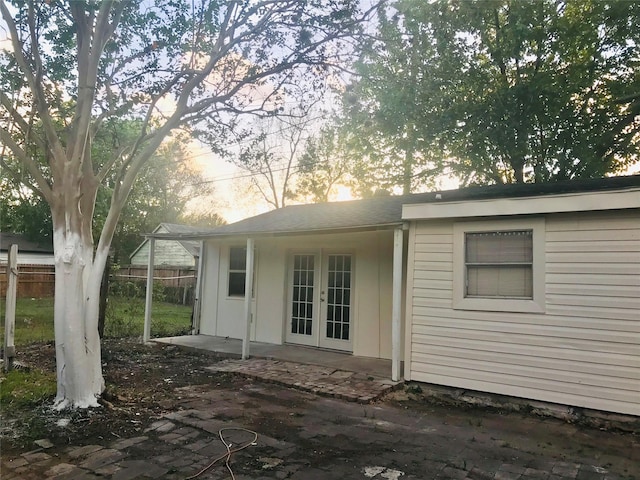 property exterior at dusk with french doors