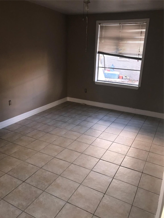 unfurnished room featuring light tile patterned floors