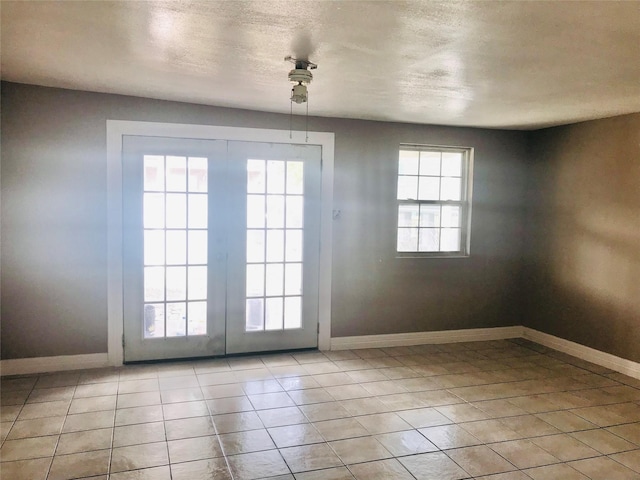 doorway featuring light tile patterned floors and a textured ceiling