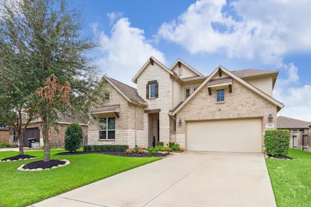 view of front of house with a garage and a front lawn