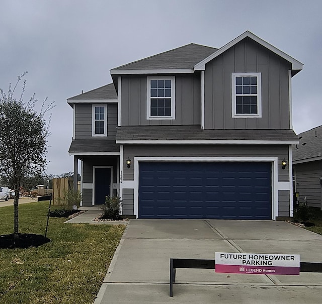 front facade featuring a front lawn and a garage