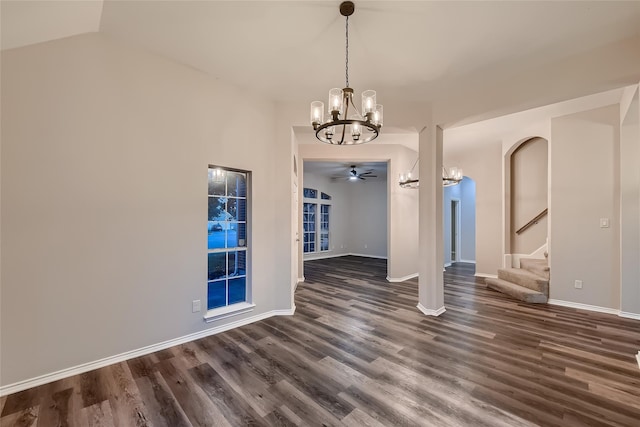 unfurnished dining area with vaulted ceiling, ceiling fan with notable chandelier, and dark hardwood / wood-style floors