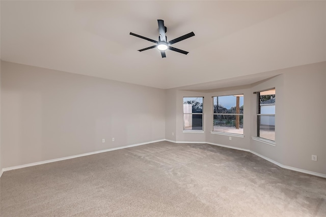 carpeted spare room featuring ceiling fan