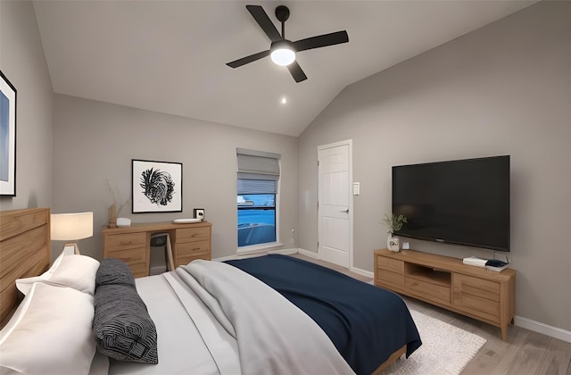 bedroom with ceiling fan, lofted ceiling, and light hardwood / wood-style flooring