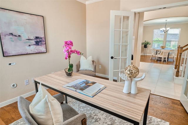 office area with a chandelier, ornamental molding, and light hardwood / wood-style flooring