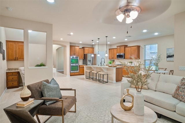 living room featuring ceiling fan and light tile patterned floors