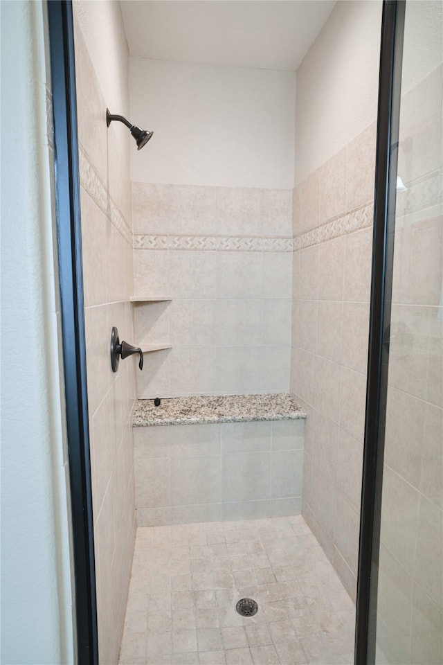 bathroom with a tile shower