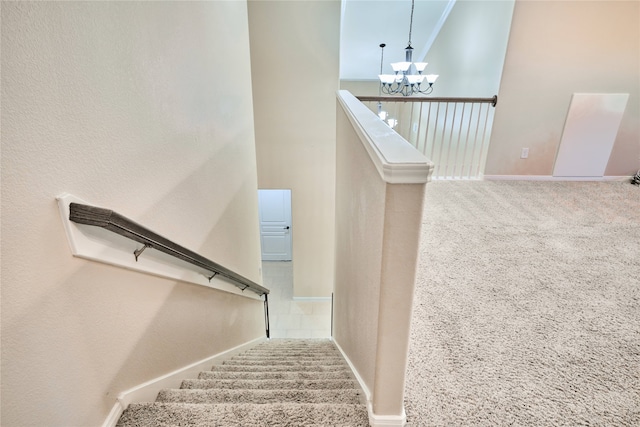 stairs with carpet, a towering ceiling, and a chandelier