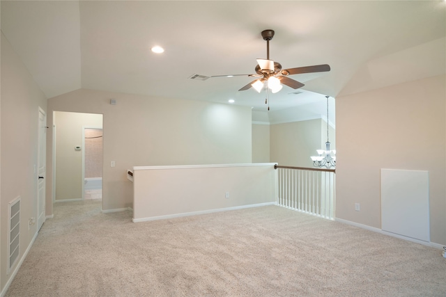 carpeted empty room with ceiling fan and vaulted ceiling