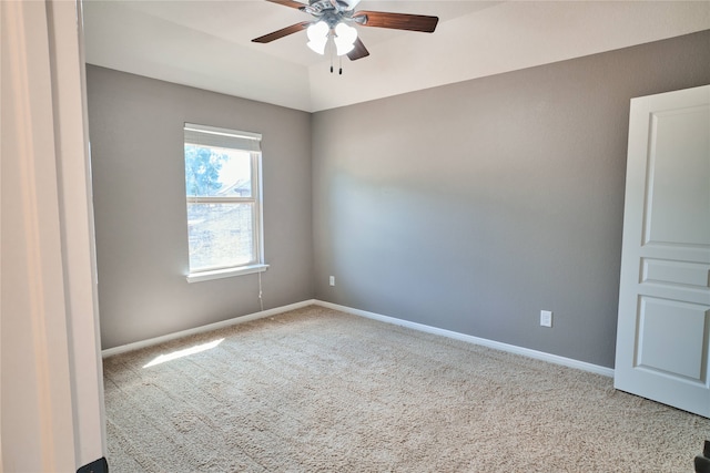 carpeted spare room featuring ceiling fan