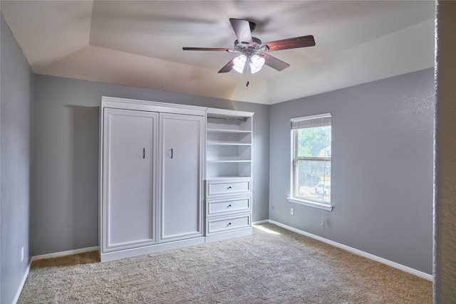 unfurnished bedroom featuring light carpet, vaulted ceiling, and ceiling fan