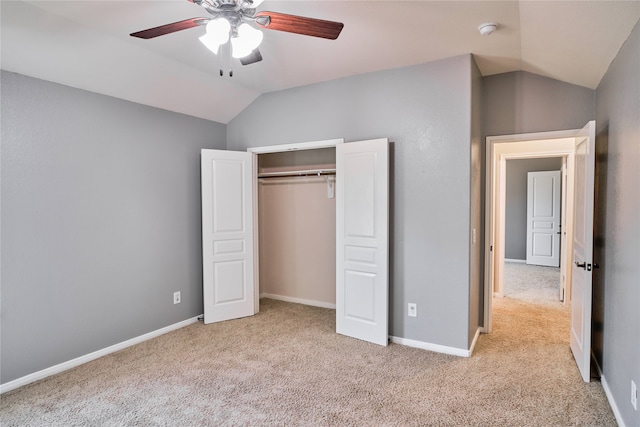 unfurnished bedroom with light carpet, a closet, ceiling fan, and lofted ceiling