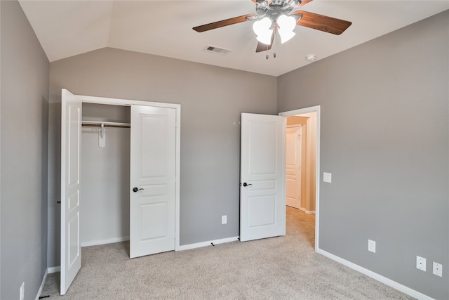 unfurnished bedroom with ceiling fan, a closet, light colored carpet, and lofted ceiling