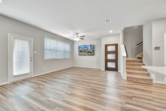 entryway with ceiling fan and light wood-type flooring