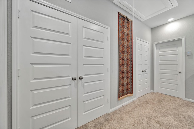 corridor with light colored carpet