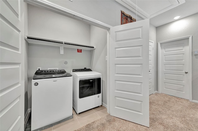 laundry room with light colored carpet, separate washer and dryer, and crown molding