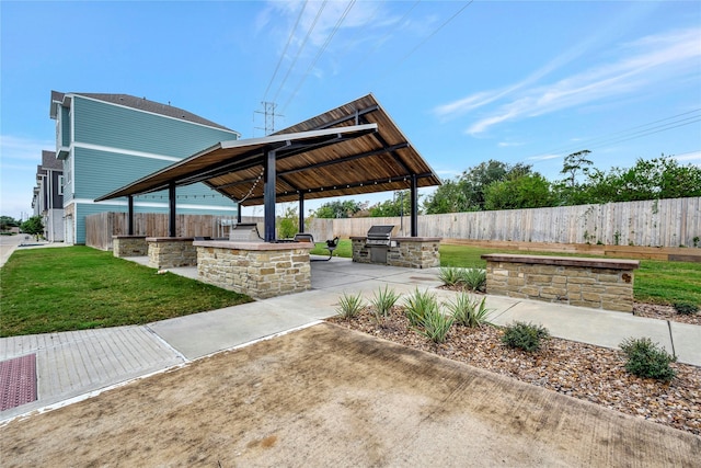 view of patio featuring a gazebo, area for grilling, and exterior kitchen