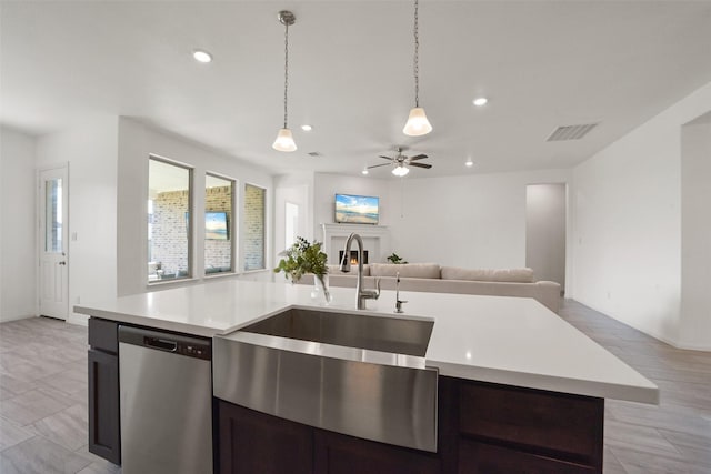 kitchen with ceiling fan, sink, pendant lighting, a center island with sink, and dishwasher