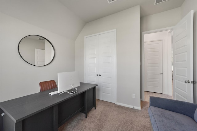 carpeted office with lofted ceiling