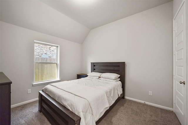 carpeted bedroom with lofted ceiling