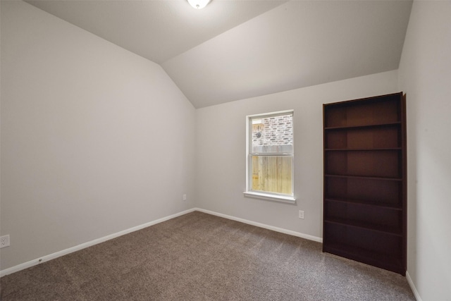 unfurnished room with carpet flooring and lofted ceiling