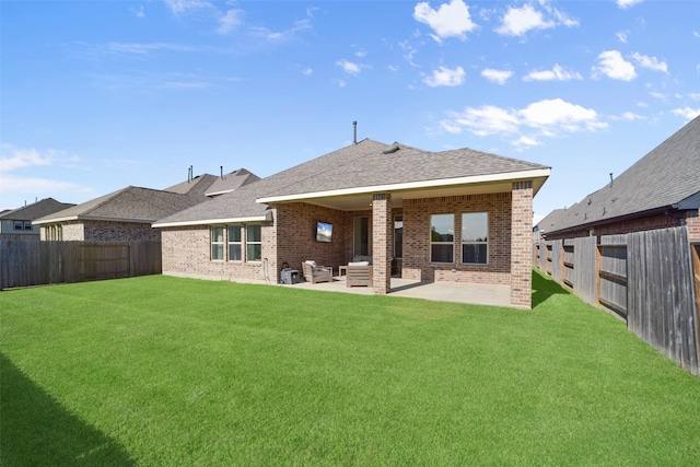 back of house featuring a yard and a patio